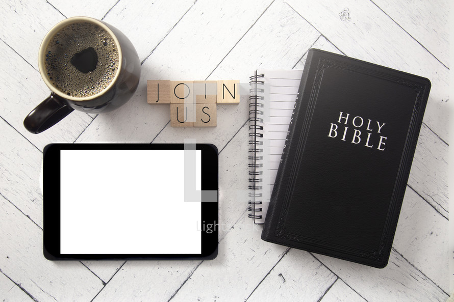 tablet, coffee cup, notebook, and Bible on a white wood background - join us