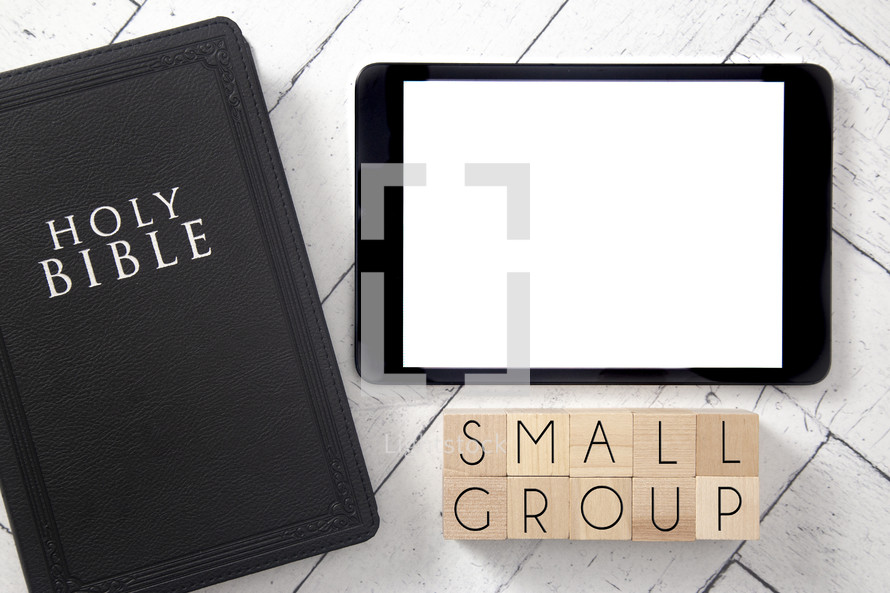 Bible and tablet on a white wood background - small group 