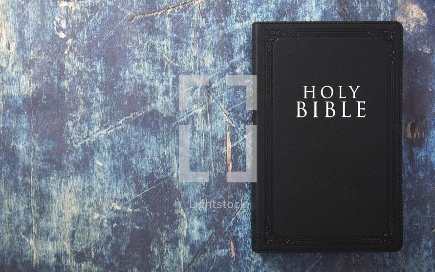 Bible on a blue grunge background 