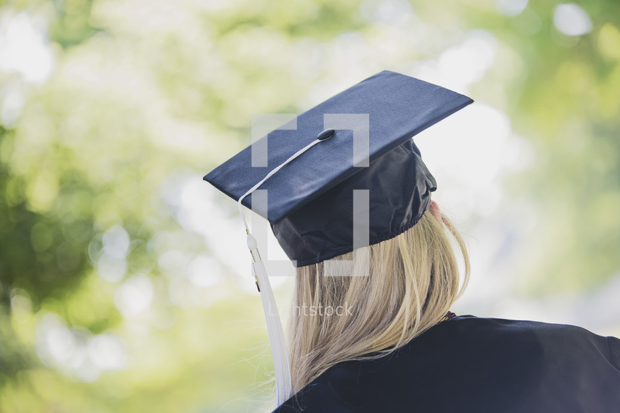 a teen girl in cap and gown for graduation 