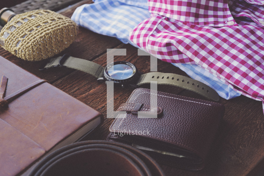 journal, wallet, leather, belt, flask, folded shirts, shirts, watch, travel, packing, trip, table, men's items, father's day 