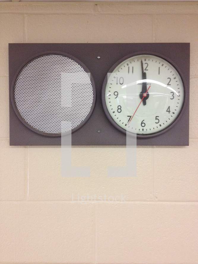 clock and speaker on a wall 