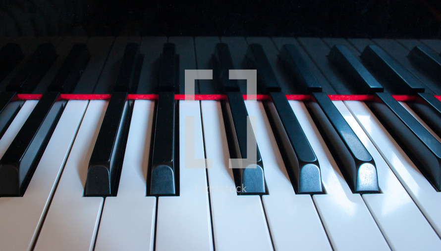 Keys reflecting on piano close-up horizontal