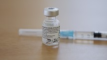 COVID-19 vaccine bottles ready for injection on a hospital table
