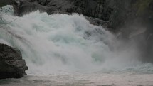 Massive water flowing down a mighty waterfall in Norway
