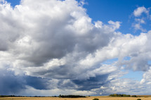 cloudy sky over a plowed field 