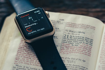 smartwatch on the pages of a Bible 