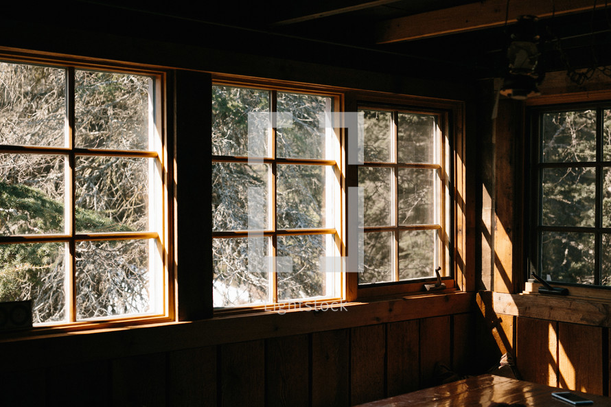 Sunlight coming through windows in wood cabin