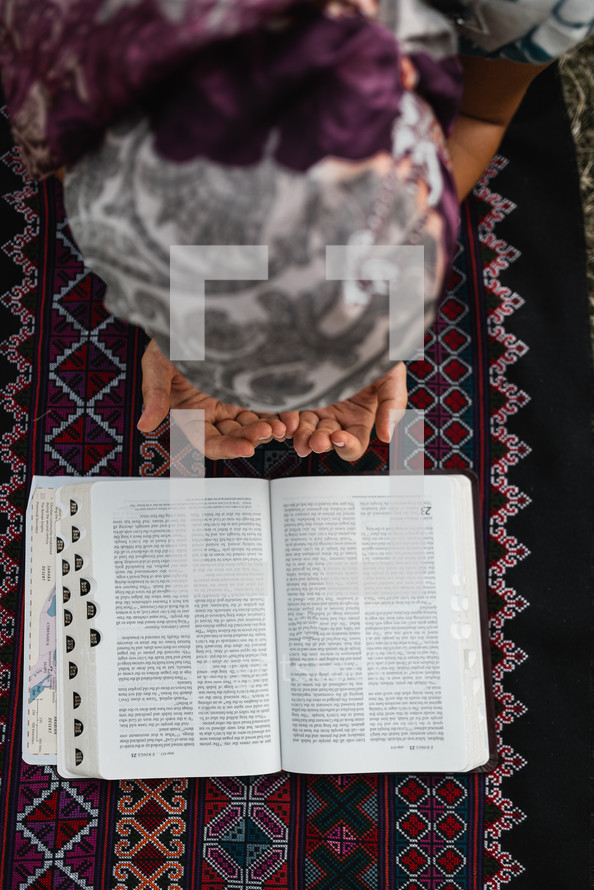 girl kneeling in front of a Bible 