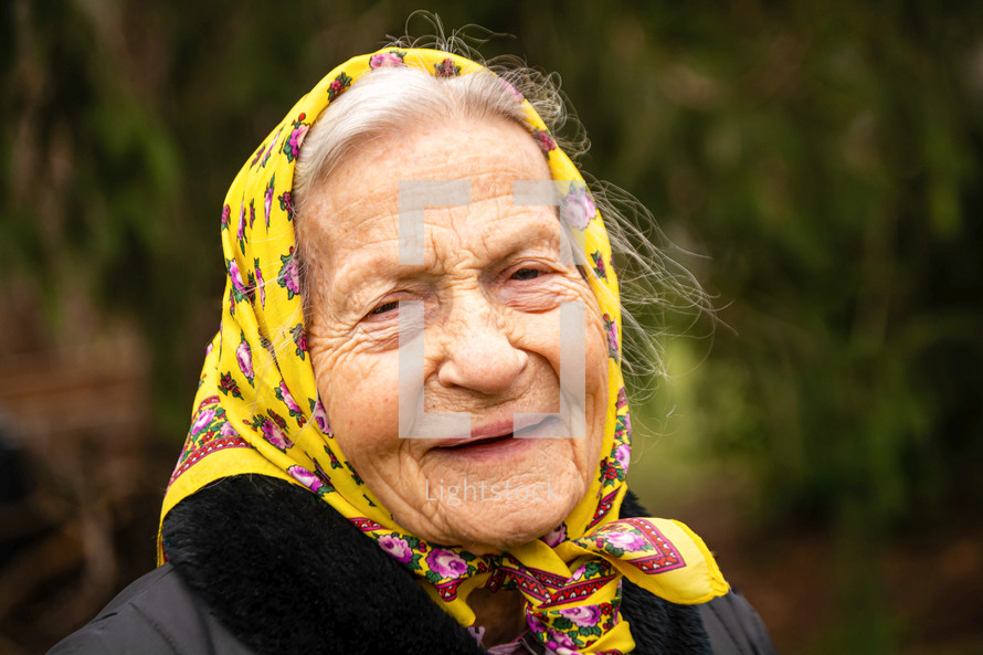 elderly woman with a handkerchief over her hair 
