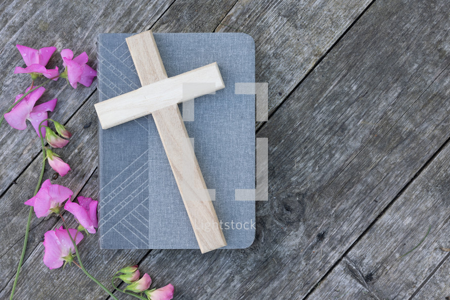 pink flowers, Cross on book and rustic wood