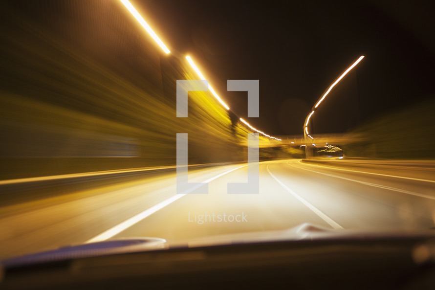 A car driving on a motorway at night