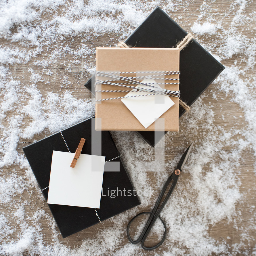 gift  boxes in snow on wood 