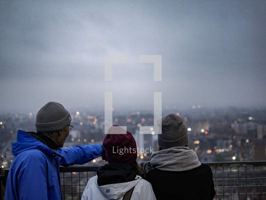 People looking out at a view over a foggy Gdansk, Poland 