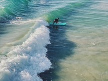 surfer catching a wave