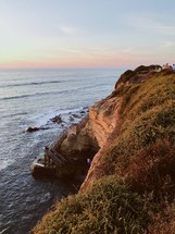 surfers, steps, and cliffs along a shore 