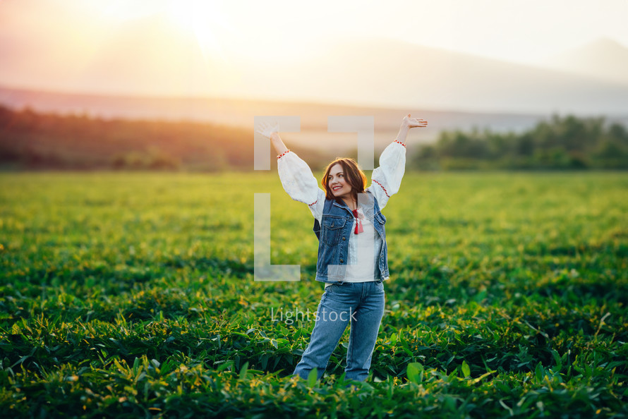 Woman with open up arms to sun. Hands up. Free girl, amazing summer adventure, countryside, rural scene. High quality