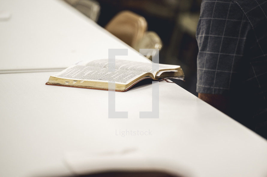 Man reading his Bible on a table during a Bible study