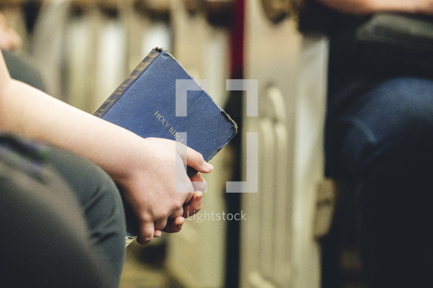 Teenager holding a Bible