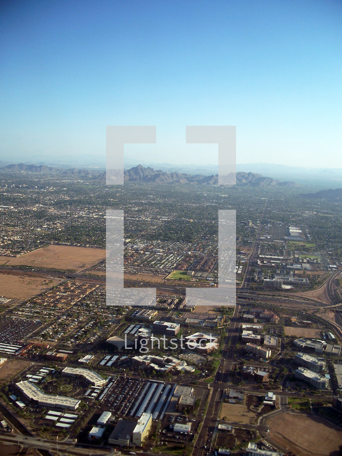 An aerial view of the earth over the mountains and city of Phoenix Arizona taken from an overhead observation airplane.  