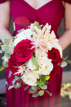 bridesmaid holding a bouquet of flowers 