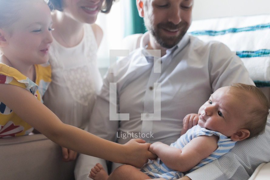 family holding a newborn baby 