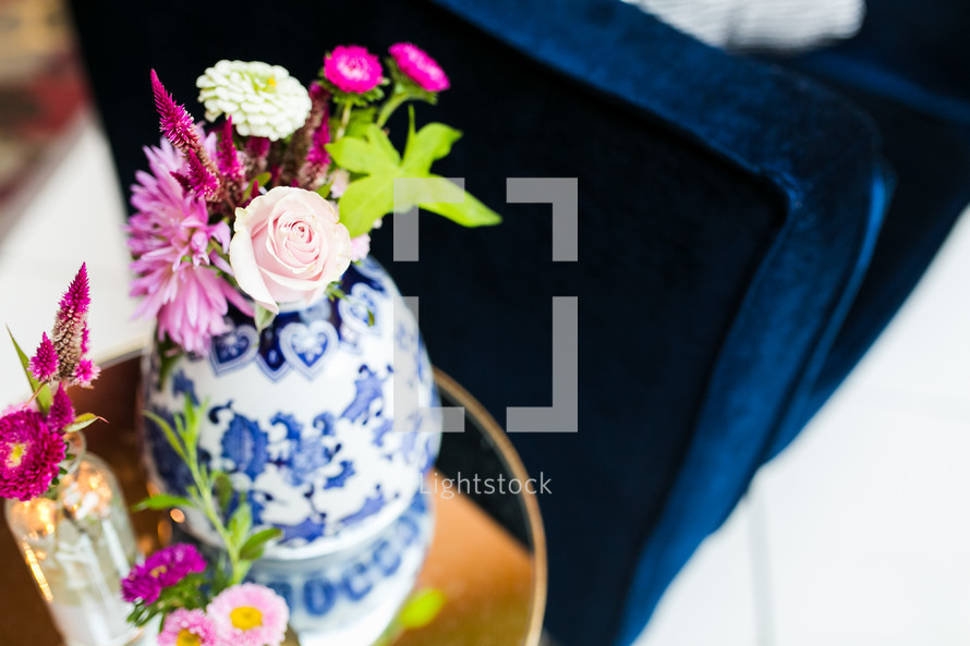 pink flowers in a blue and white porcelain vase 