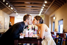 Bride and groom eating at fastfood restaurant