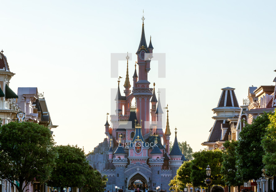 Paris, France - June 02, 2023: Castle of Disneyland Paris Park photographed from the main street in the lights of the sunset.
