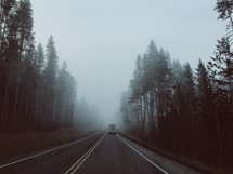 truck on a foggy rural road 