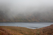 Two People with Mist Hovering Over Lough Bray, County Wicklow