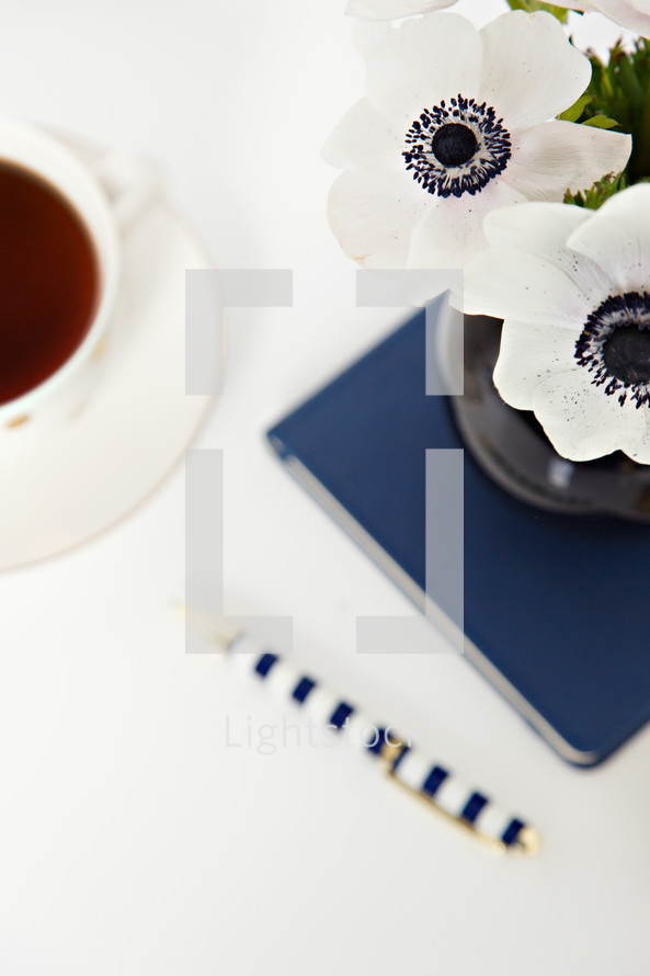 tea, flowers, journal and pen