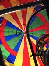 looking up at the colorful fabric in a hot air balloon 