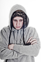 man with his arms folded in a toboggan and sweatshirt 