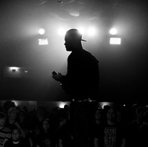 silhouette of a man holding a microphone