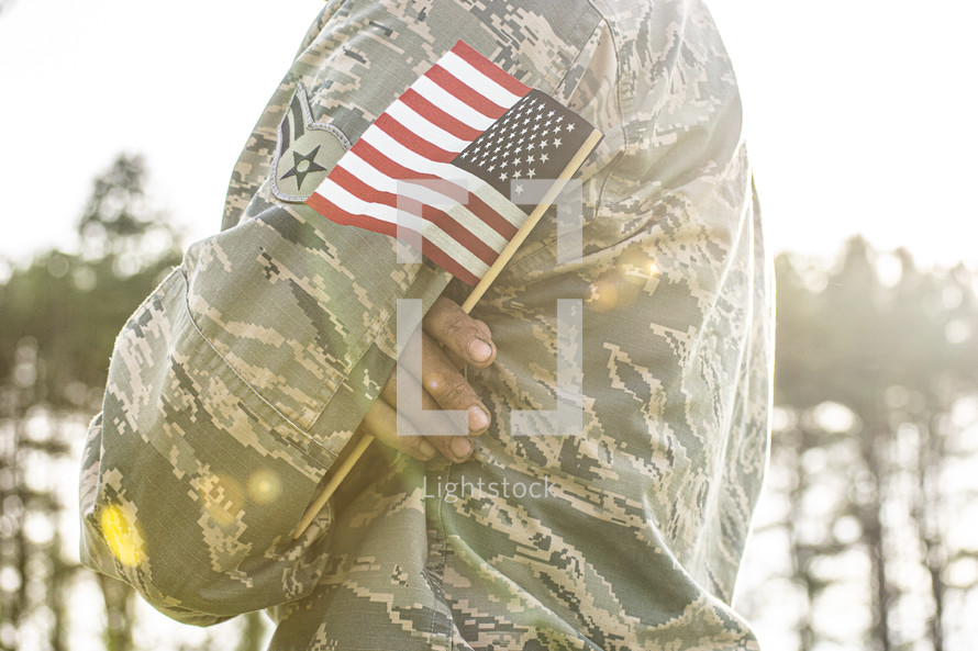 soldier holding an American flag 