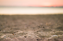 Close up of sandy beach at sunset