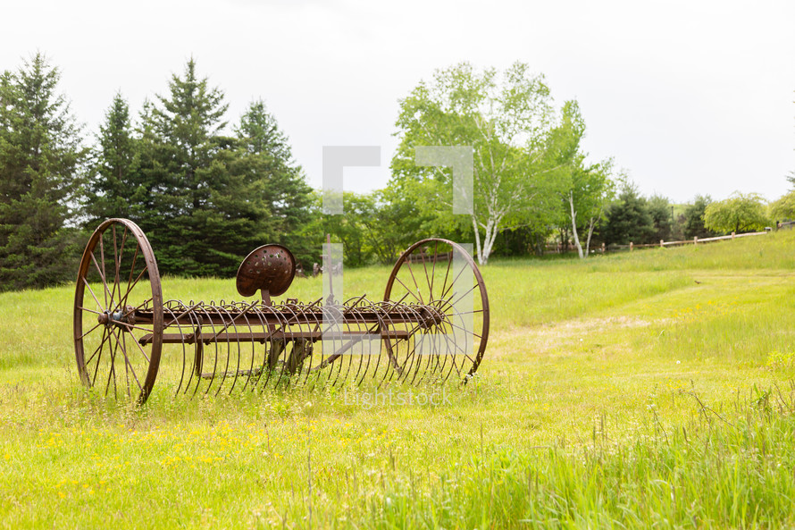 Old farm equipment in field