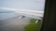 View Of The Coast From An Airplane Window	