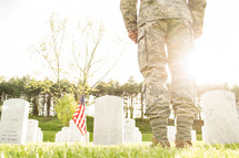 soldier standing in front of a cemetery 