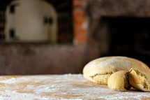 Homemade bread on floured surface in historic kitchen