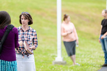 Women discussing Bible in outdoor park