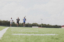 men running at football practice 