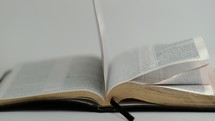 close up of flipping pages of a Bible 