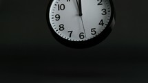 falling wall clock against black background