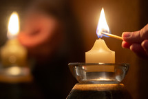 lighting candles with a match 