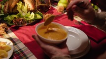 Hand serving sauce for roasted turkey on Thanksgiving 