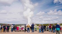  Tourists on the boardwalk watch as Old Faithful Geyser erupts in Yellowstone National Park, Wyoming, USA 