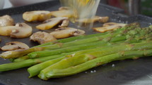 Grilling asparagus and mushrooms with the addition of two chicken eggs