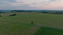 Aerial footage of a field dotted with hay bales, rural Germany landscape